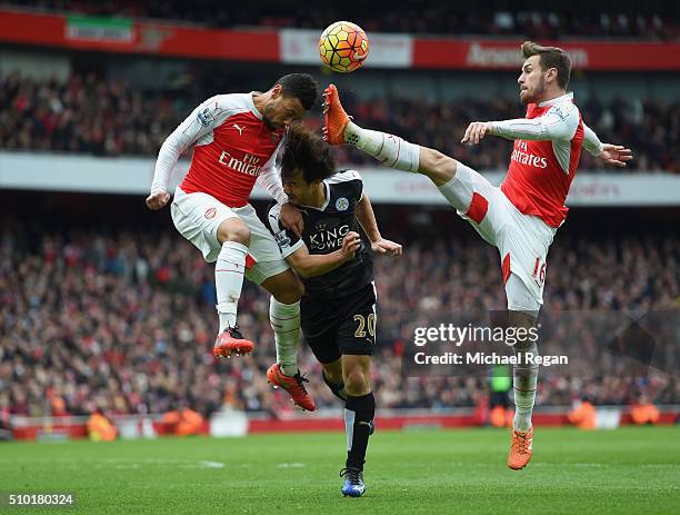 Francis Coquelin and Aaron Ramsey of Arsenal in action with Shinji Okazaki of Leicester City during the Barclays Premier League match between Arsenal...