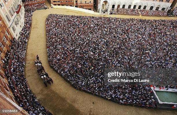 Italian Paramilitary Police "Carabinieri" horse patrol ride their horses in Piazza del Campo prior the start of the fifth trial called "general...