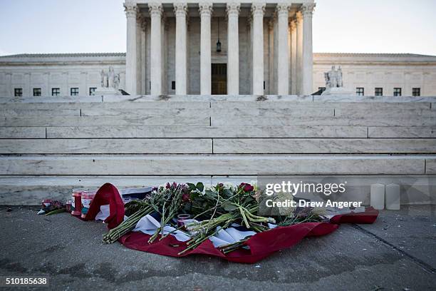 Flowers and candles sit at the bottom of the steps at the U.S. Supreme Court following the death of Supreme Court Justice Antonin Scalia February 14,...