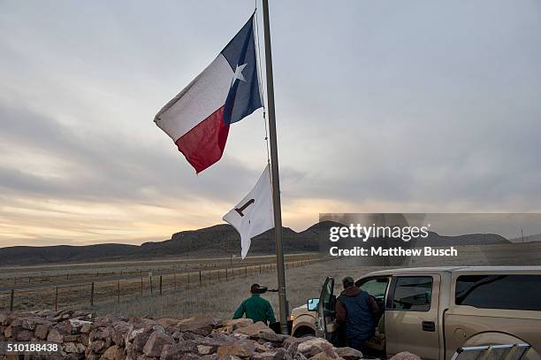 Workers at Cibolo Creek Ranch lower the Texas flag to half mast on Sunday, the day after the death of Supreme Court Justice Antonin Scalia, February...