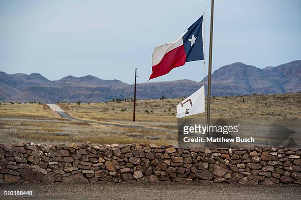The Texas flag flies at half mast on Sunday at the Cibolo Creek Ranch, the day after the death of Supreme Court Justice Antonin Scalia February 14,...