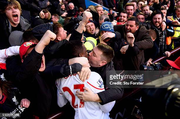 Liverpool fan kisses Divock Origi of Liverpool as he celebrates after scoring his team's fourth goal during the Barclays Premier League match between...