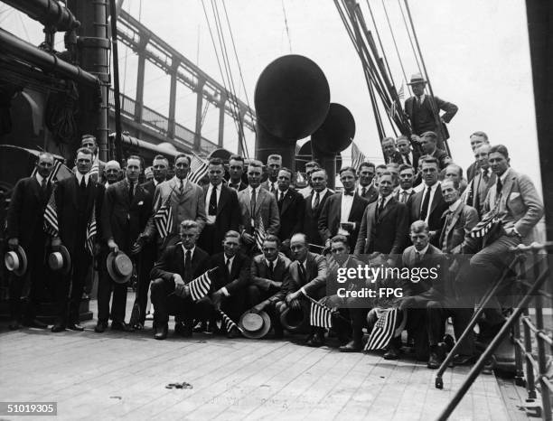 Members of the American Olympics team on the transport ship Sherman pass under a bridge as they set sail to Antwerp , 1920. Among the athletes are 20...