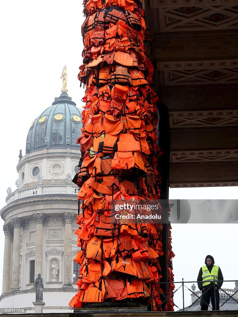 Artist Ai Weiwei covers Berlin venue with used life jackets 