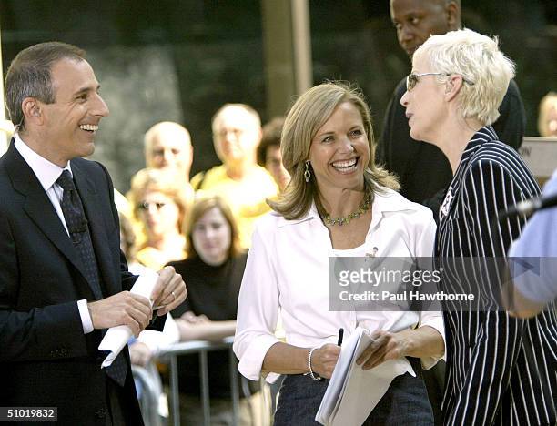 Show hosts Matt Lauer and Katie Couric talk with singer Annie Lennox before Lennox performed live on NBC's "Today" show in Rockefeller Plaza July 2,...