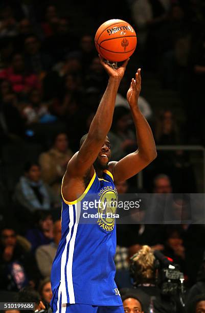 Draymond Green of the Golden State Warriors shoots against actor Kevin Hart before the Foot Locker Three-Point Contest during NBA All-Star Weekend...