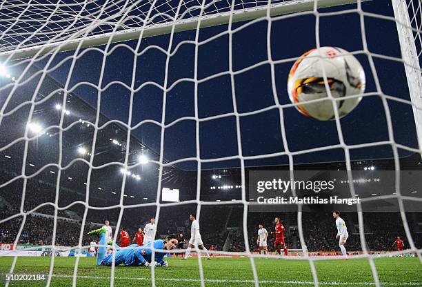 Goalkeeper Marwin Hitz of Augsburg looks on as Robert Lewandowski of Bayern Munich scores their first goal during the Bundesliga match between FC...