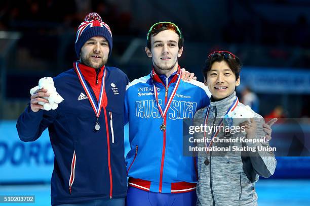 Paul Stanley of Great Britain poses during the medal ceremony after winning the 2nd place , Dmitry Migunov of Russia poses during the medal ceremony...