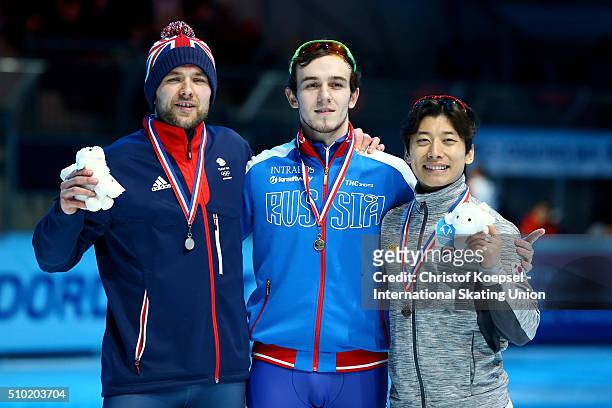 Paul Stanley of Great Britain poses during the medal ceremony after winning the 2nd place , Dmitry Migunov of Russia poses during the medal ceremony...