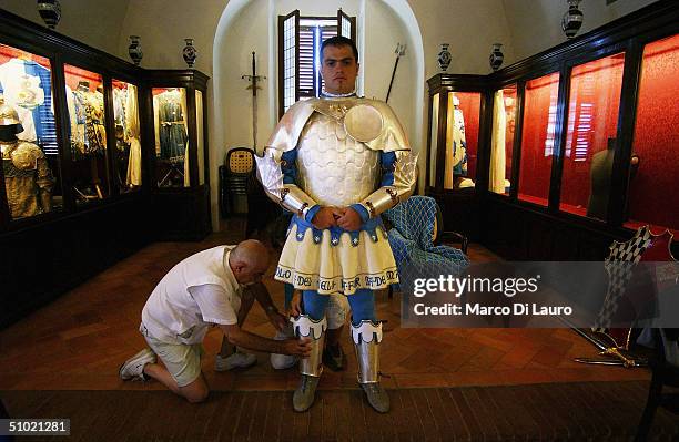 The group of costumed partecipants who represent the Contrada of the Onda prepare themselves for the historic parade that take place in Piazza del...