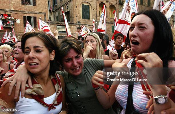 The Contradaioli belonging to the Giraffa , one of the seventeen Contrade or neighborooud, celebrate after their jockey and horse won the Palio horse...