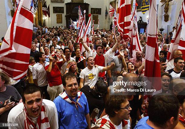 The Contradaioli belonging to the Giraffa , one of the seventeen Contrade or neighborooud, celebrate after their jockey and horse won the Palio horse...