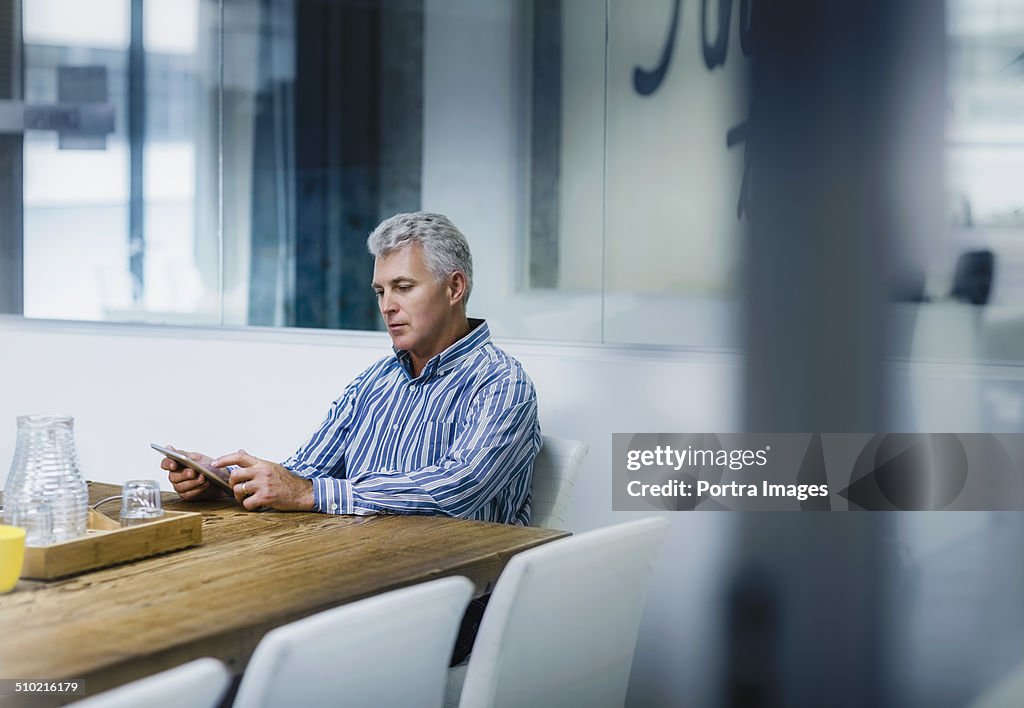 Businessman using digital tablet in office