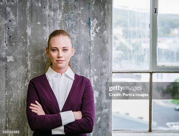 beautiful businessman standing against wall - hair back ストックフォトと画像