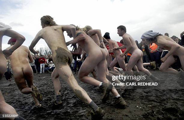 Men start the traditional Nude Race at the Roskilde Festival 03 July 2004. The fastest of the runners were awarded T-shirts, tents and skin care...