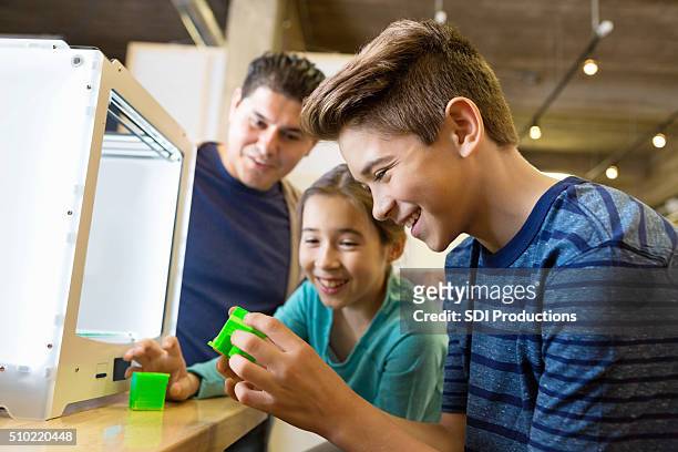 father and kids printing 3d objects with 3d printer - 3d printers stock pictures, royalty-free photos & images