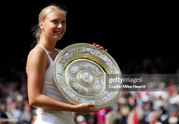 Maria Sharapova of Russia poses with her trophy after she won against Serena Williams of USA in the ladies final match at the Wimbledon Lawn Tennis...