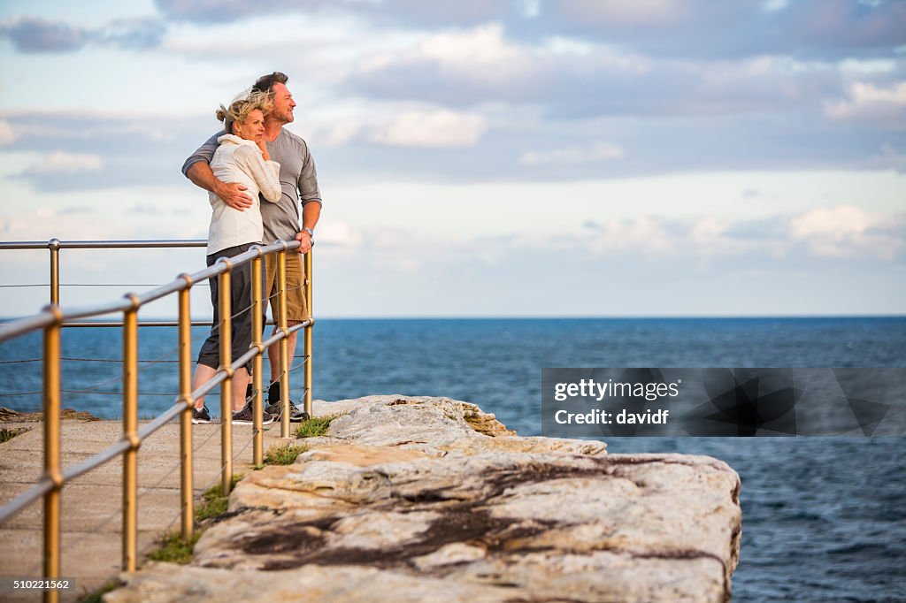 Loving Happy Middle Aged Fit Healthy Beach Couple at Sunset