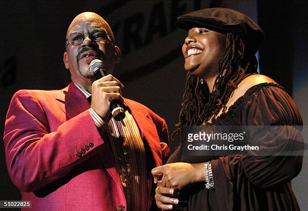 Host Tom Joyner talks with singer Lalah Hathaway, the daughter of singer Donnie Hathaway, during a break in the music at the 10th Anniversary Essence...