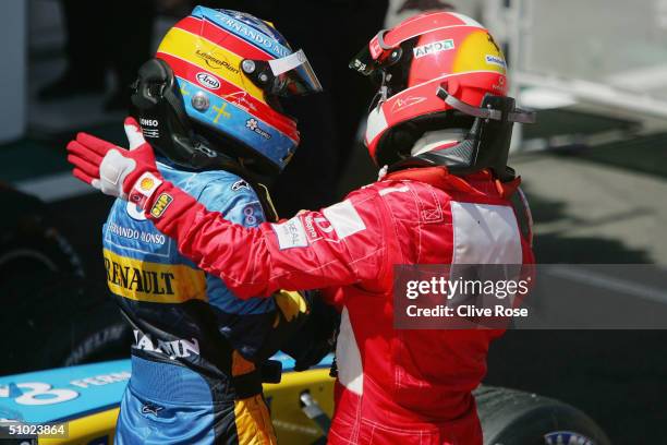 Michael Schumacher of Germany and Ferrari congratulates Fernando Alonso after the French F1 Grand Prix at the Magny-Cours Circuit on July 4 in...