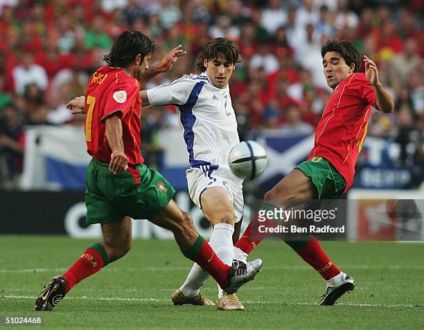 Georgios Seitaridis of Greece battles with Luis Figo and Deco of Portugal during the UEFA Euro 2004 Final match between Portugal and Greece at the...
