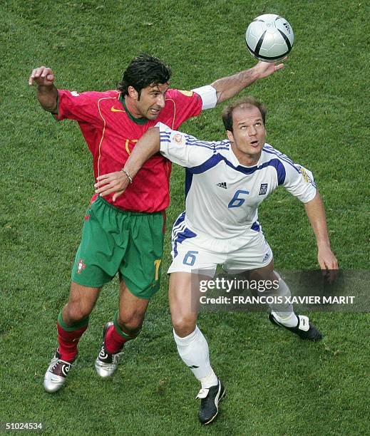 Greek midfielder Angelis Basinas vies with Portuguese forward Luis Figo , 04 July 2004 at Stadio da Luz in Lisbon, during the Euro 2004 final...