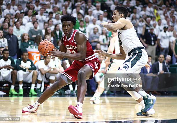 Anunoby of the Indiana Hoosiers drives around against Kenny Goins of the Michigan State Spartans in the first half at the Breslin Center on February...