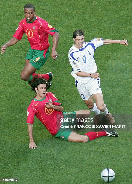 Greece's forward Angelos Charisteas is tackled by Portuguese defender Ricardo Carvalho , 04 July 2004 at Stadio da Luz in Lisbon, during the Euro...