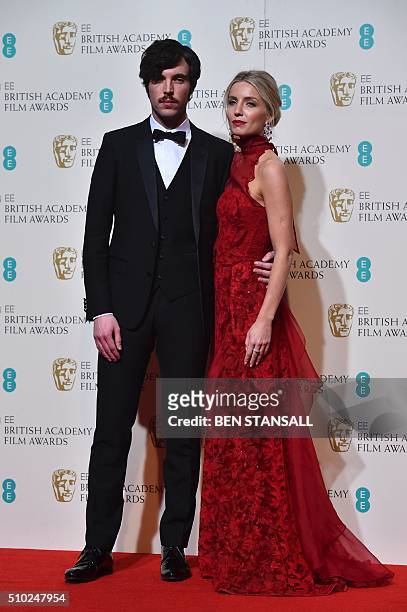 Award presenters British actress Annabelle Wallis and Tom Hughes pose together in the winners area at the BAFTA British Academy Film Awards at the...