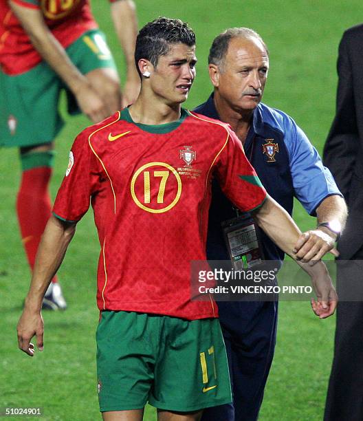 Portuguese forward Cristiano Ronaldo is consoled by coach Luiz Felipe Scolari, 04 July 2004 at the Estadio da Luz in Lisbon after losing the European...