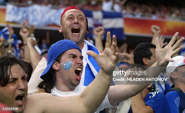 Greek supporters celebrate, 04 july 2004 at the Stadio Da Luz in Lisbon, after the Euro 2004 final match between Portugal and Greece at the European...