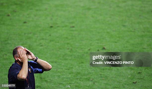 Portugal's coach Luiz Felipe Scolari holds his head in his hands, 04 july 2004 at the Stadio Da Luz in Lisbon after the Euro 2004 final match between...