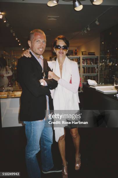 American fashion designer, Cynthia Rowley and her husband, gallery owner and writer, Bill Powers, at an art gallery in East Hampton, New York, USA,...