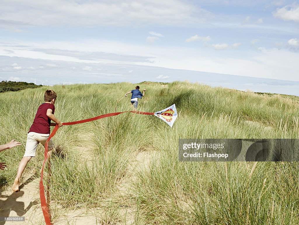 Children flying a kite at the beach