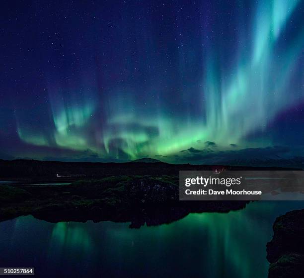 aurora over the silfra rift in iceland - thingvellir stock pictures, royalty-free photos & images