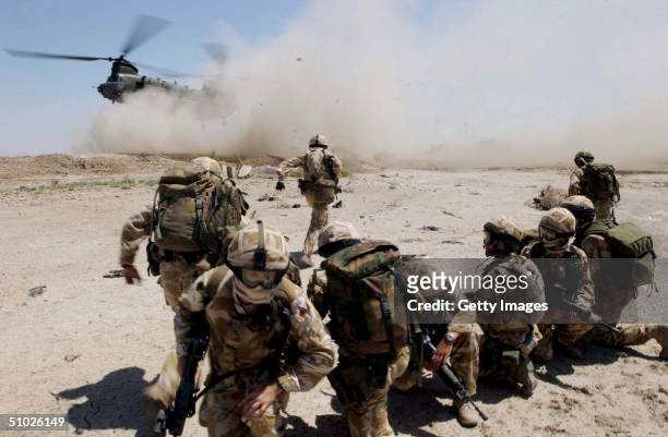 In this handout from the British Army, soldiers from the The Royal Welch Fusiliers mount helicopter borne Eagle VCP's , July 2, 2004 around the...
