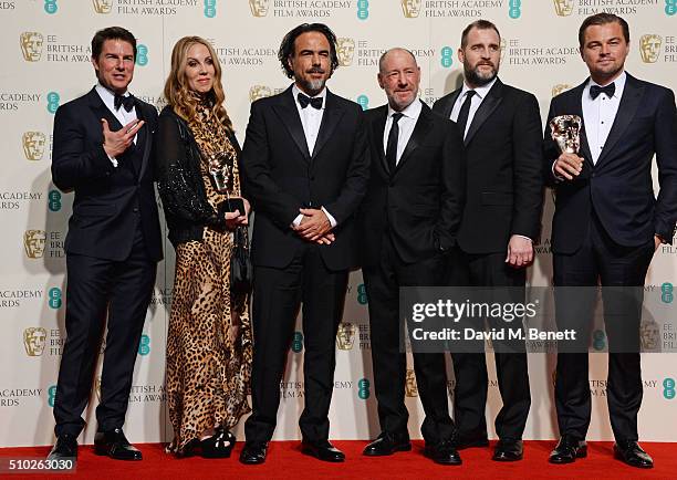 Presenter Tom Cruise poses with Best Film winners Mary Parent, Alejandro Gonzalez Inarritu, Steve Golin, Keith Redmon and Best Actor winner Leonardo...