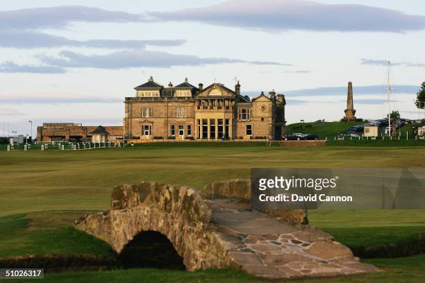 The Swilcan Bridge with the par 4 18th hole and the Royal and Ancient Golf Club of St Andrews Clubhouse behind on the Old Course at St Andrews, on...