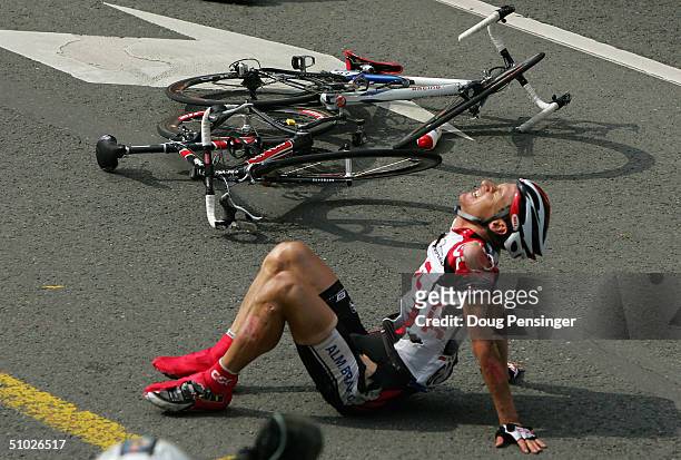 Kurt-Asle Arvesen of Norway and riding for CSC sits on the road after being involved in a crash with Jimmy Casper of France in the final 200 meters...