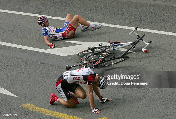 Kurt-Asle Arvesen of Norway and riding for CSC and Jimmy Casper of France and riding for Cofidis lie on the course after they crashed in the final...