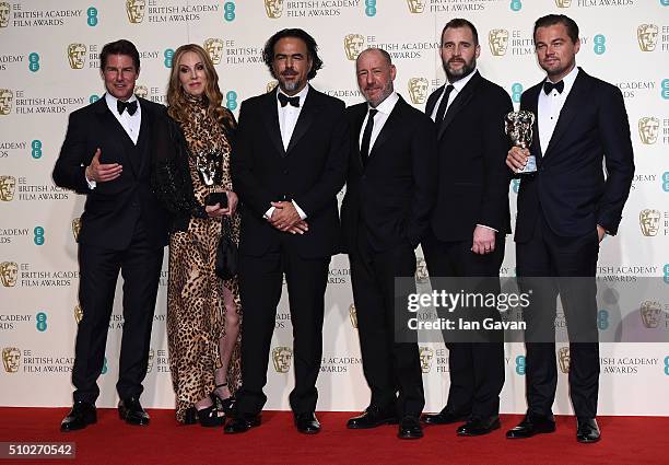 Tom Cruise poses with Best Film winners Mary Parent, Alejandro Gonzalez Inarritu, Steve Golin, Keith Redmon and Best Actor winner Leonardo DiCaprio...