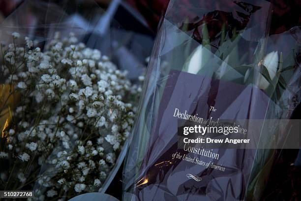 Copy of the Declaration of Independence and Constitution rests with flowers at a makeshift memorial for Supreme Court Justice Antonin Scalia at the...