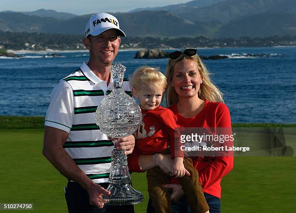Vaughn Taylor poses with the trophy, along with wife Leot and son Locklyn, after winning the AT&T Pebble Beach National Pro-Am at the Pebble Beach...