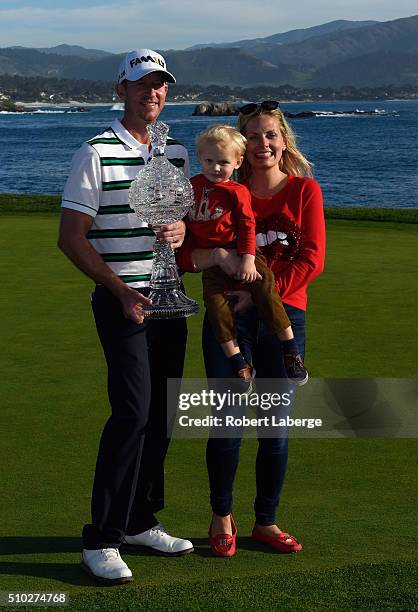 Vaughn Taylor poses with the trophy, along with wife Leot and son Locklyn, after winning the AT&T Pebble Beach National Pro-Am at the Pebble Beach...