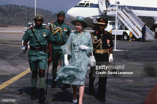 Queen Elizabeth II is escorted by soldiers from Papua New Guinea on her arrival at the airport on October 13, 1982 in Port Moresby, Papua New Guinea....