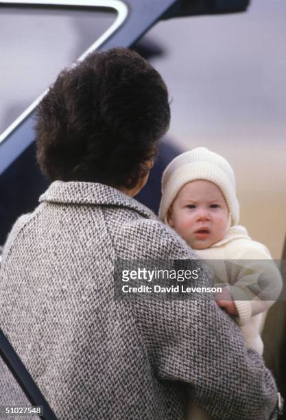 Prince Harry is carried by his nanny, Barbara Barnes, on March 25, 1985 onto the Royal flight leaving Aberdeen airport in Scotland.
