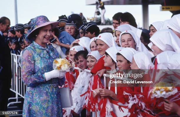 Queen Elizabeth II meeting a group of Red Cross students, on arrival at Brisbane International Airport on October 6, 1982 in Brisbane, Australia at...