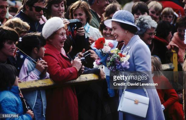 Queen Elizabeth II meeting crowds lining the streets leading to City Hall on September 11, 1982 in Bathurst, Australia during the Royal Tour of...