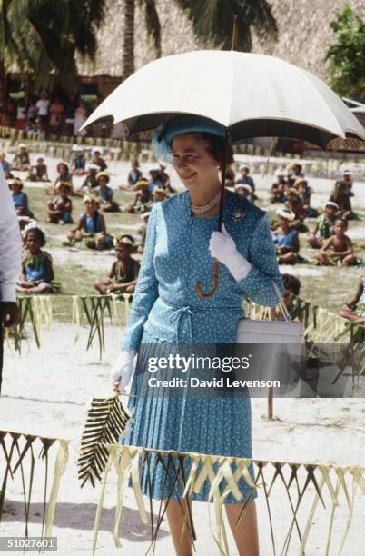 Queen Elizabeth II sheltering from the midday sun outside the Princess Margaret Hospital on October 27, 1982 in Funafuti, Tuvalu during the Royal...