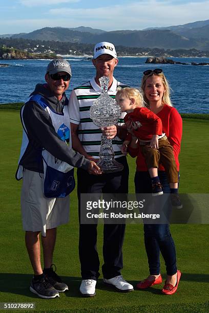 Vaughn Taylor poses with the trophy, along with wife Leot, son Locklyn, and caddie Dan Padawer after winning the AT&T Pebble Beach National Pro-Am at...